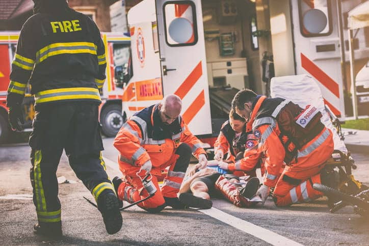 Paramedics assisting a victim after a catastrophic injury.